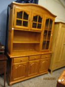 STAINED PINE DISPLAY CABINET, THE TOP FITTED WITH THREE GLAZED DOORS WITH OPEN SHELF, THE BASE