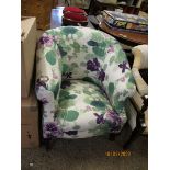EDWARDIAN FLORAL UPHOLSTERED TUB CHAIR WITH CABRIOLE FRONT LEGS RAISED ON BRASS CASTERS