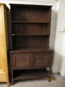 EARLY 20TH CENTURY OAK FRAMED DRESSER WITH TWO FIXED SHELVES AND PANEL BACK WITH TWO CUPBOARD