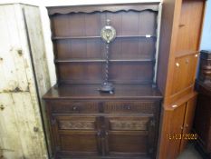 OAK FRAMED DRESSER WITH TWO FIXED SHELVES AND PANELLED BACK, THE BASE WITH TWO DRAWERS OVER TWO