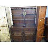 OAK FRAMED DRESSER WITH TWO FIXED SHELVES AND PANELLED BACK, THE BASE WITH TWO DRAWERS OVER TWO