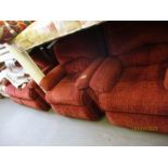 RED UPHOLSTERED THREE PIECE SUITE COMPRISING A TWO-SEATER SOFA AND TWO ARMCHAIRS