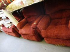 RED UPHOLSTERED THREE PIECE SUITE COMPRISING A TWO-SEATER SOFA AND TWO ARMCHAIRS