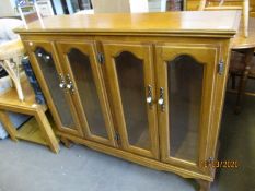 OAK FRAMED BOOKCASE WITH FOUR GLAZED DOORS WITH PORCELAIN KNOB HANDLES