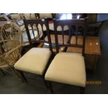 PAIR OF EDWARDIAN MAHOGANY FRAMED SPINDLE BACK DINING CHAIRS WITH TURNED FRONT LEGS WITH CREAM