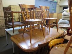 STAINED PINE EXTENDING DINING TABLE WITH A SET OF SIX PINE HARD SEATED SPLAT BACK CHAIRS (7)