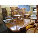 STAINED PINE EXTENDING DINING TABLE WITH A SET OF SIX PINE HARD SEATED SPLAT BACK CHAIRS (7)