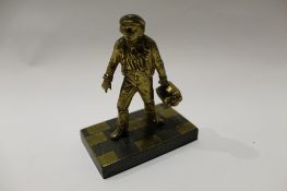 Small gilt bronze figure of a workman carrying a toolbox in his left hand, 11cm high