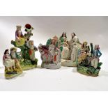 Group of Staffordshire figures including two ladies, grape pickers in Middle Eastern dress and