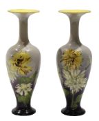 Pair of late 19th century Doulton Lambeth faience vases decorated with flowers on a grey ground, the
