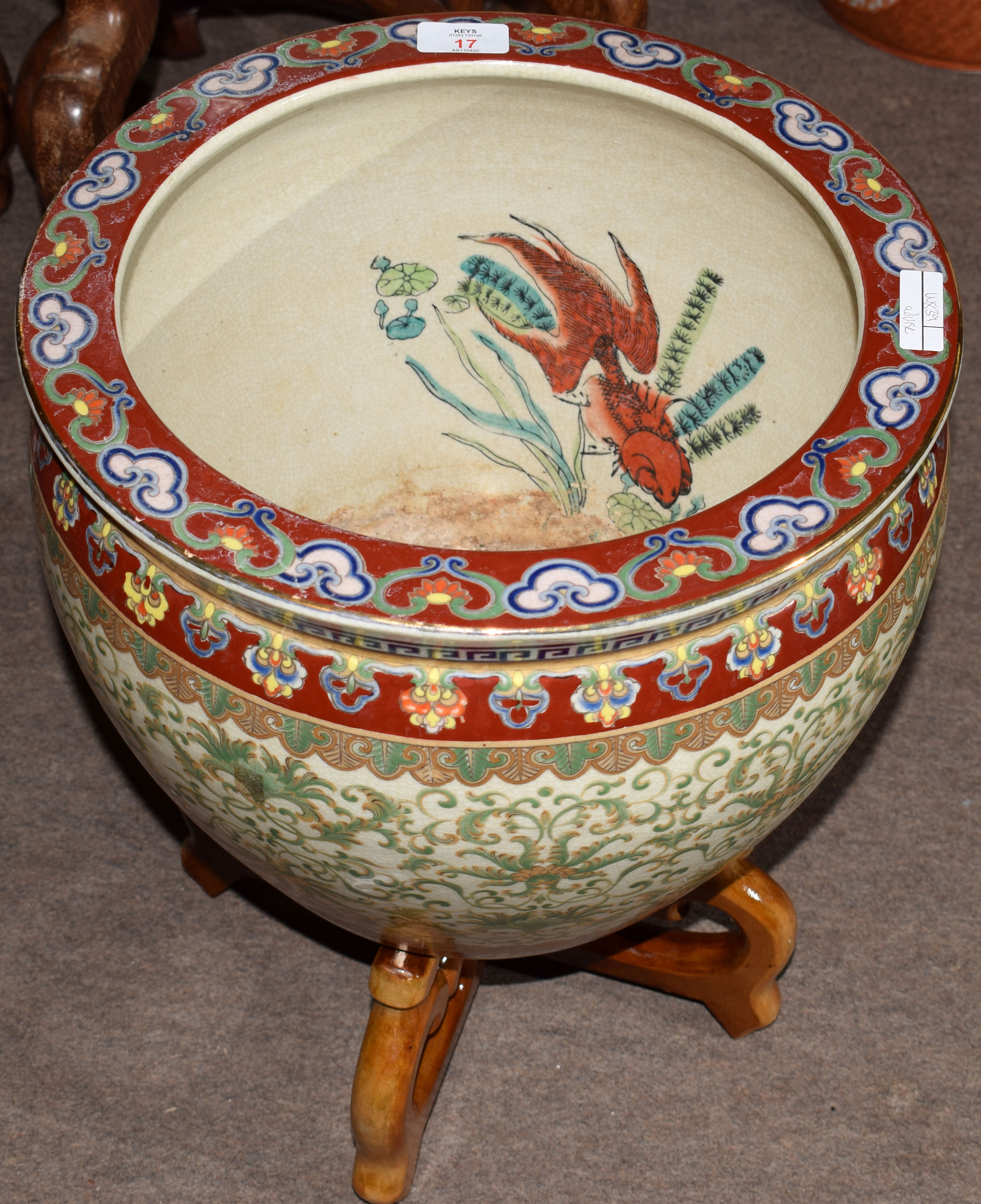 Chinese porcelain fish bowl with a scrolling design in green enamel below a polychrome rim mounted