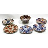 Group of Japanese porcelain wares including three Arita plates with blue and white designs and