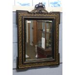 19th century ebonised and parcel gilded wall mirror with shell crested top, 56cm wide