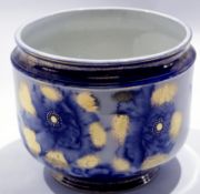 Late 19th century jardiniere, the white ground decorated with blue flowers and gilt surround, 24cm