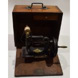 Late 19th century small cast metal framed hand sewing machine dated July 1891 in a drop front