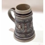 German stoneware 1ltr ale jug or tankard decorated in relief in manganese with typical applied