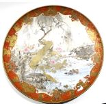 Large Satsuma dish, Meiji period, the centre decorated with a landscape scene and mountains with