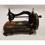 Late 19th century black cast metal sewing machine, indistinct trademark with the head and