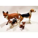 Beswick model of a fox, together with a smaller model of a fox and with two models of hounds