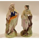 Two Staffordshire figures of a man and a lady in Middle Eastern dress