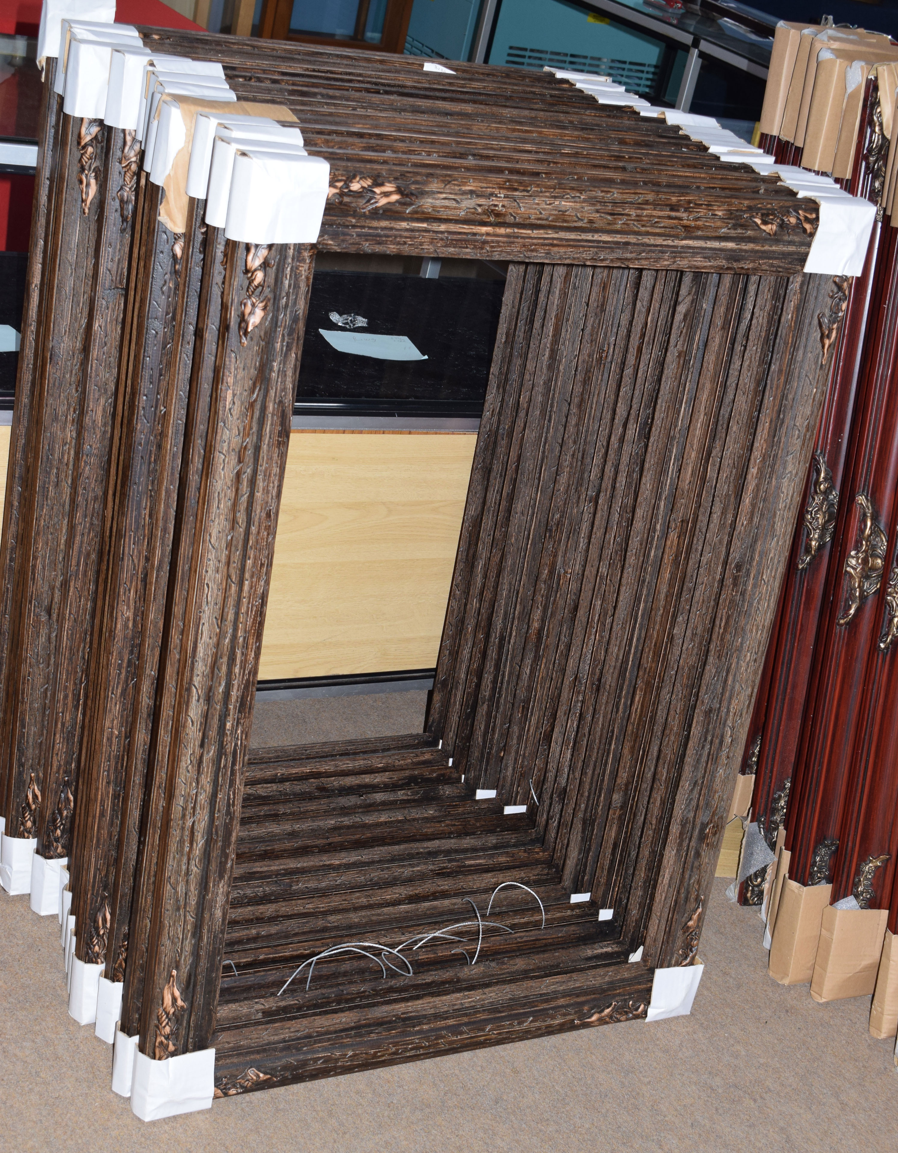 Group of 14 modern wooden picture frames with foliate decoration to corners, rebate size 60 x