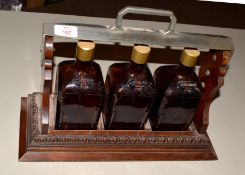 Set of three Cointreau bottles in wooden rack with carrying handle, inscribed "Presented to H. Grant