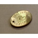 An oval 33 x 25mm mother of pearl Midland Railway free ticket token with hole for suspension.