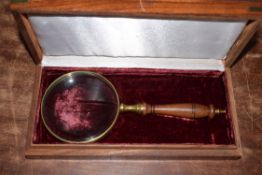 Magnifying glass 10cm dia with brass surround, in wooden case 27 x 13 x 5cm.
