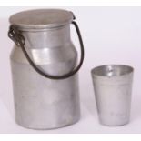 Unmarked miniature churn in aluminium 15cm high x 9cm dia, dented, together with small aluminium cup
