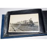 Blue photo album 23 x 14cm containing approx 45 purchased railway-interest postcard size b/w