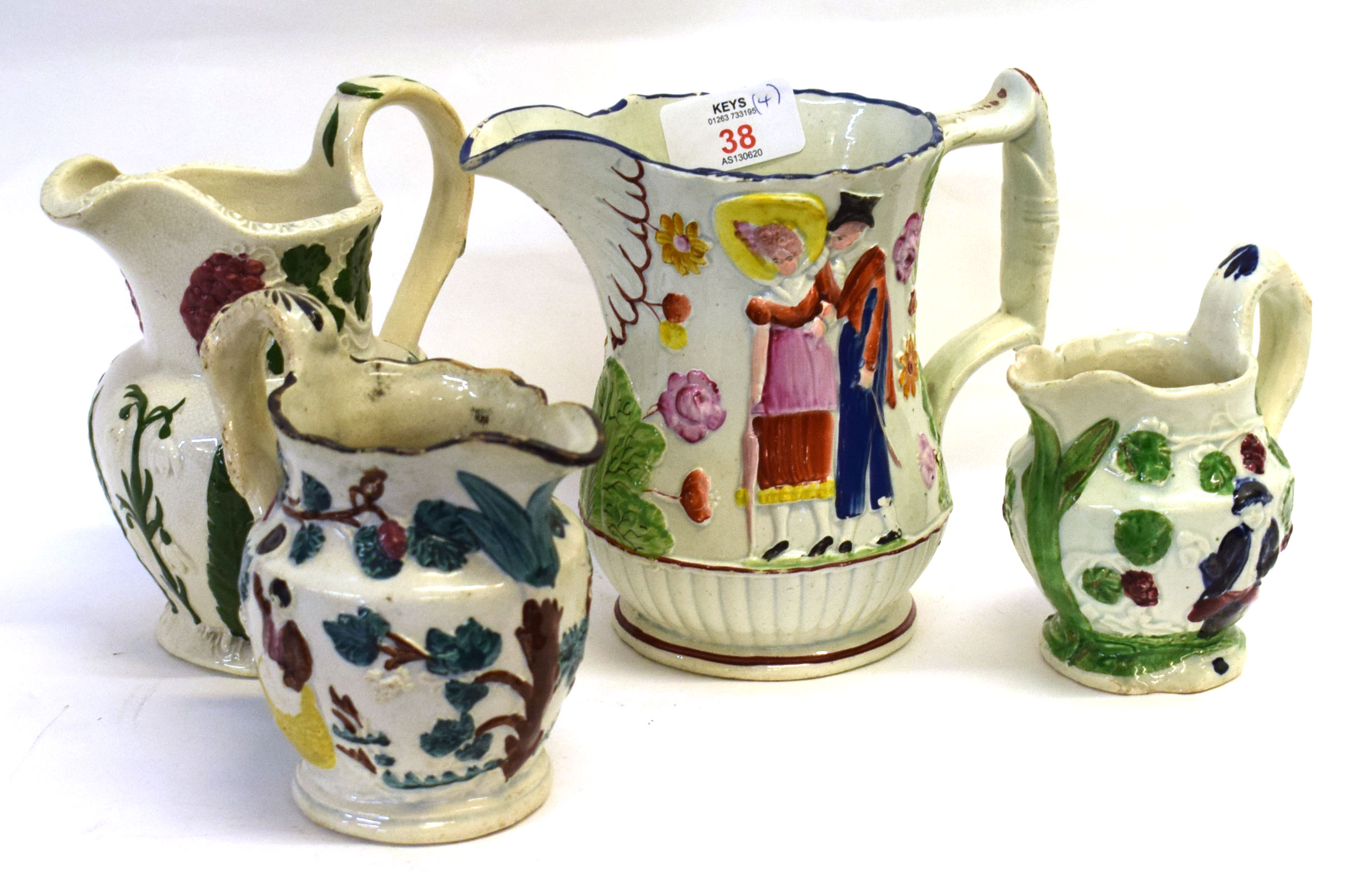 Group of 4 early 19th Century Pearlware jugs, 1 decorated in relief with promenaders, the other 3