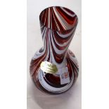 Red Art glass vase decorated with white swirls with Unikat sticker