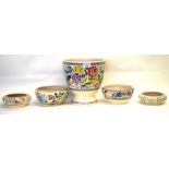 Group of Poole pottery wares with floral designs including Jardiniere and 4 bowls, Jardiniere 23cm