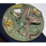 Portuguese or Pallasey style dish, the interior decorated in relief with a snake, insects, lizard