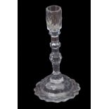 Late 18th century/19th century faceted glass candlestick with faceted sconce above a three knop