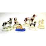 Group of Staffordshire dog models on moulded bases, together with 2 Staffordshire models of deer