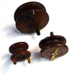 Collection of three early 20th century wooden fishing reels with brass mounts, one impressed "