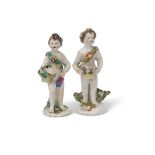 Two Bow porcelain putti, both modelled carrying baskets of flowers, 13cm high (2)