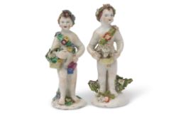 Two Bow porcelain putti, both modelled carrying baskets of flowers, 13cm high (2)