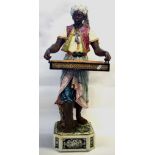 Large late 19th Century Continental pottery figure, modelled as a Moor, in Majolica glazes,