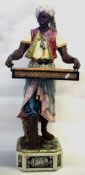 Large late 19th Century Continental pottery figure, modelled as a Moor, in Majolica glazes,