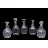 Group of four 19th century cut glass decanters with mushroom stoppers, together with a further
