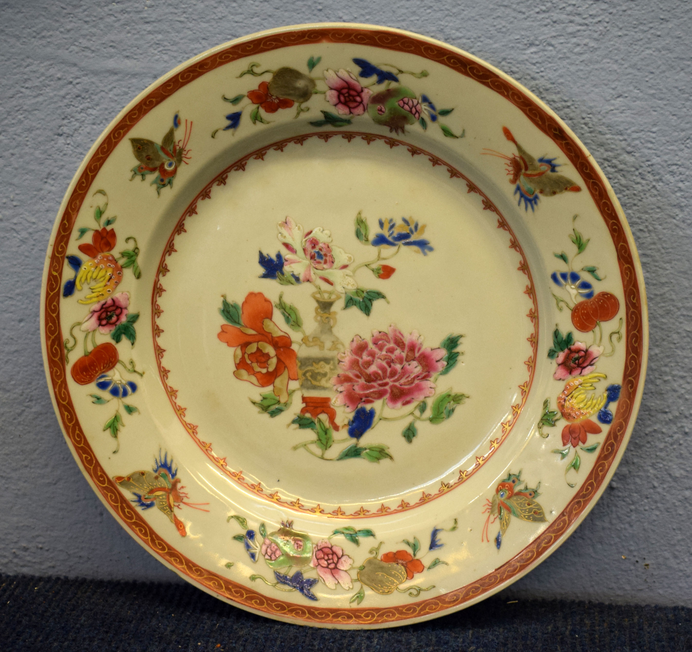 18th century Chinese porcelain plate decorated in famille rose style with a vase and flowers, the