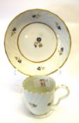 English porcelain wrythen shaped cup and saucer, cup with ear shaped handle and floral designs in