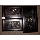 Group of three carved Oriental hardwood panels with ivory inlay featuring immortals, in a wooded