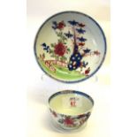 Lowestoft porcelain tea bowl and saucer with a Redgrave design of flowers with rock work against a