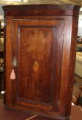 18th century oak wall mounting corner cupboard, panelled door inlaid in the centre with birds on a