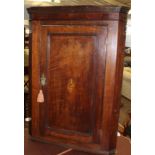 18th century oak wall mounting corner cupboard, panelled door inlaid in the centre with birds on a