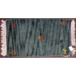 Late 20th century small thick green woollen pile prayer rug with animal motifs to corners and