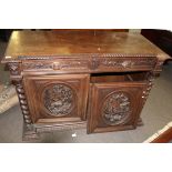 Heavy Gothic oak carved sideboard with two frieze drawers over panelled door carved in the centre